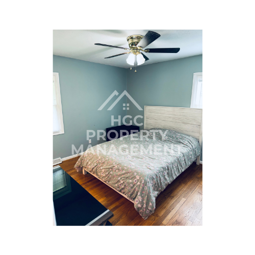 a bedroom with a bed and a ceiling fan