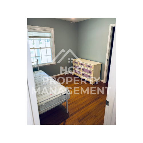 a bedroom with a dresser and a bed