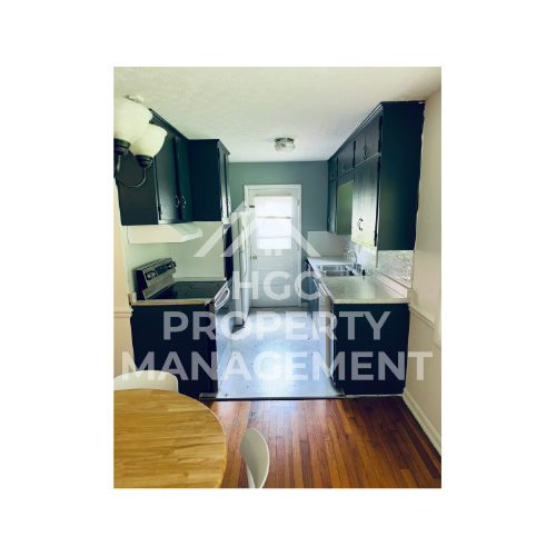 a small apartment with a kitchen and a table