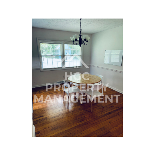 a living room with a wood floor and a table