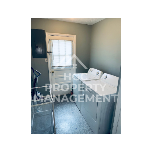 a small room with a bed and a sink