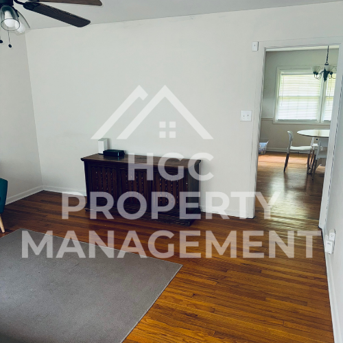 a living room with a hard wood floor and a property management