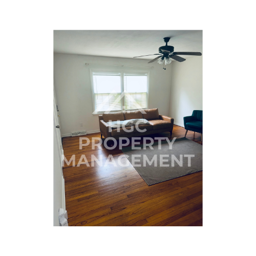 a living room with a couch and a ceiling fan