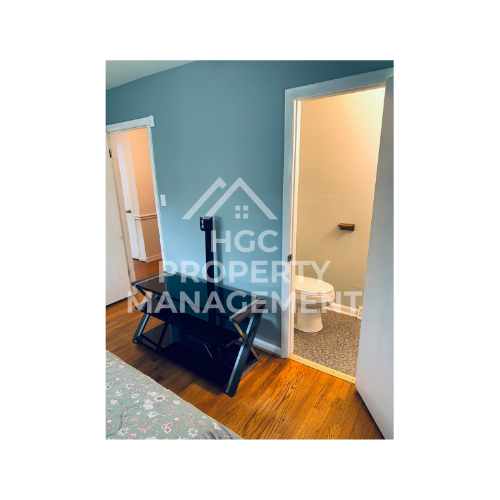 a large bedroom with a closet and a bathroom