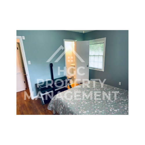 a bedroom with a bed and a door to a closet