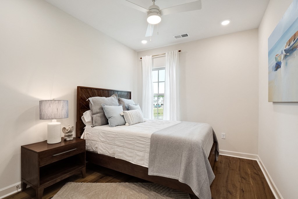 a bedroom with a large bed and a window