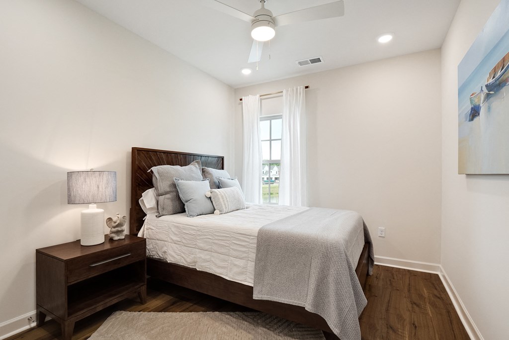 a bedroom with a large bed and a window