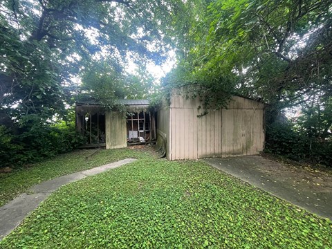 a shed in the backyard of a house