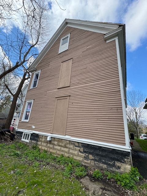 the side of a house with brown siding