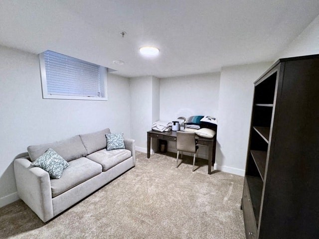 a living room with a couch and a desk