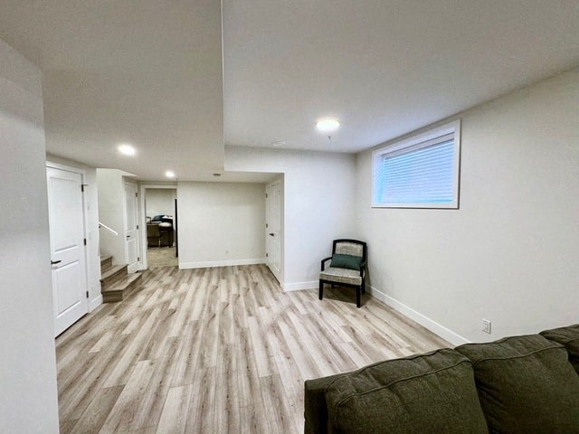 an empty living room with a couch and a chair