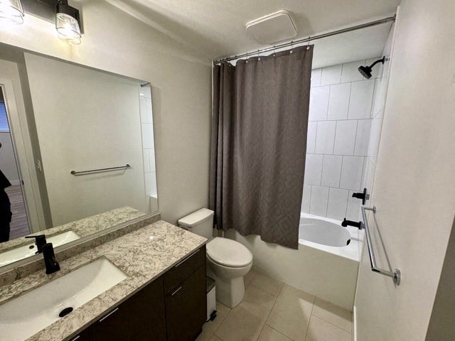 a bathroom with a toilet and a shower and a sink