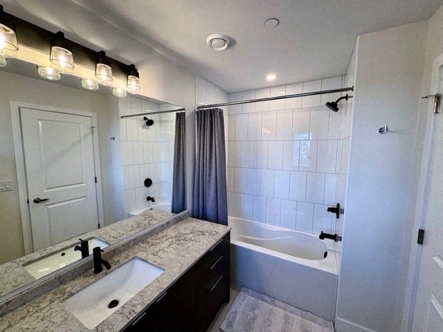 a bathroom with a sink and a tub and a shower