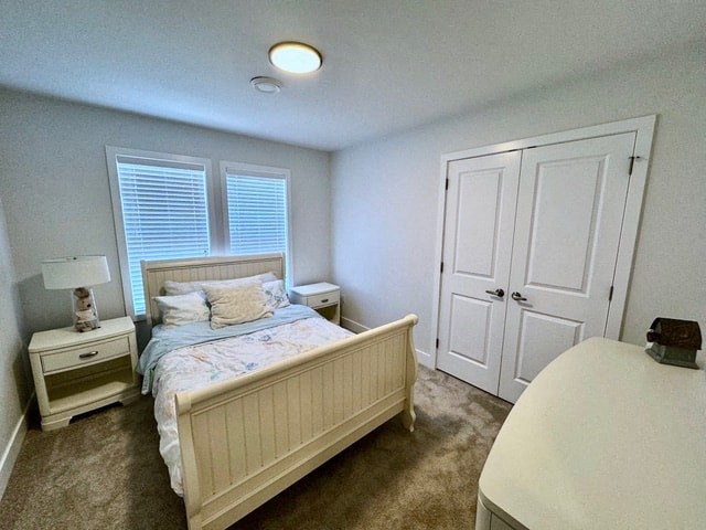a small bedroom with a bed and a closet