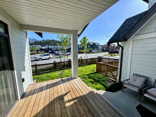 a porch with a view of a street and a house