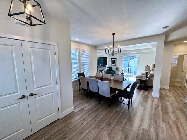 a dining room and living room with a table and chairs
