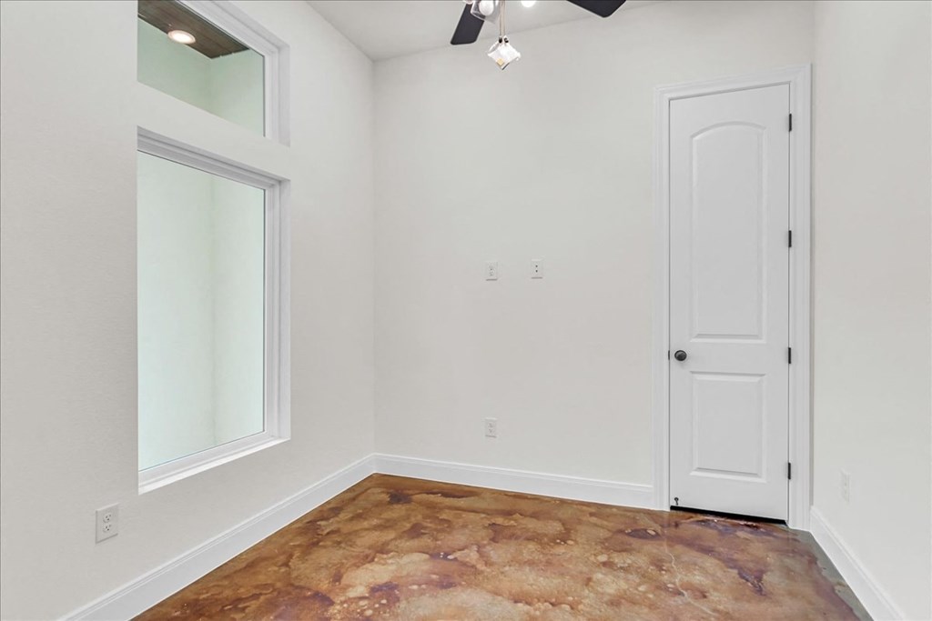 an empty room with white walls and a window and a door