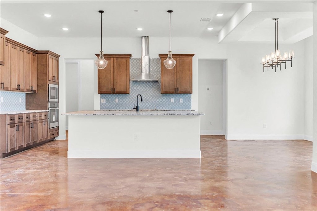 an empty kitchen with a large island in the middle