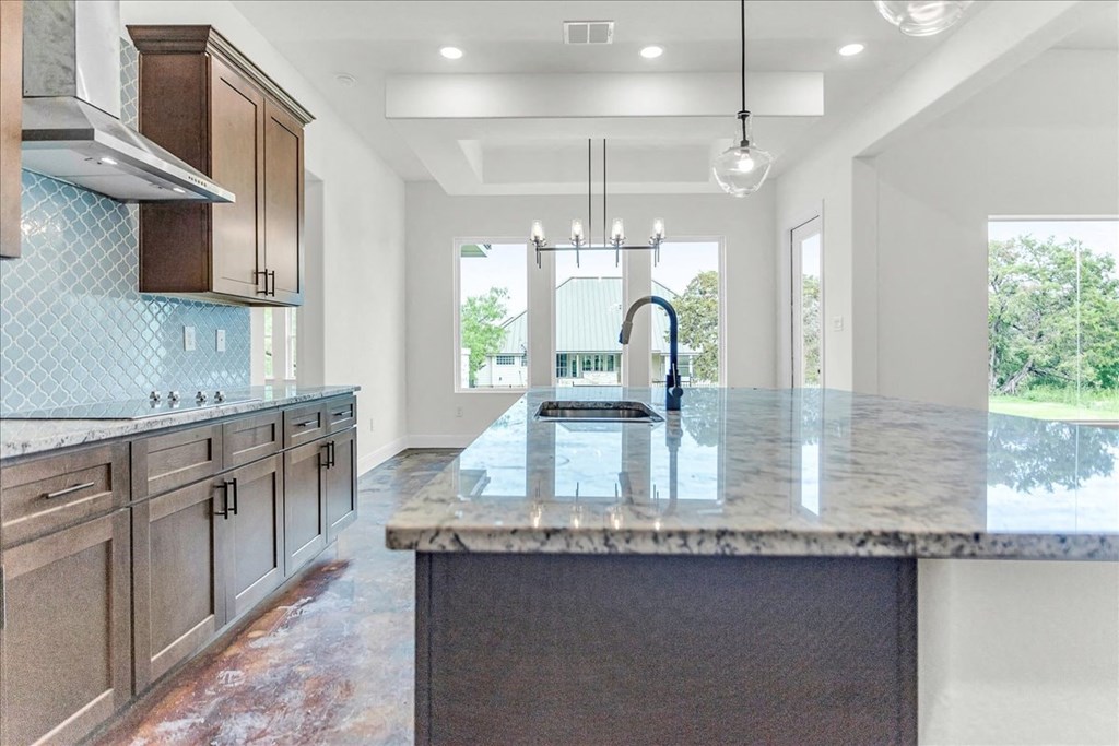 an open kitchen with a large island with a sink