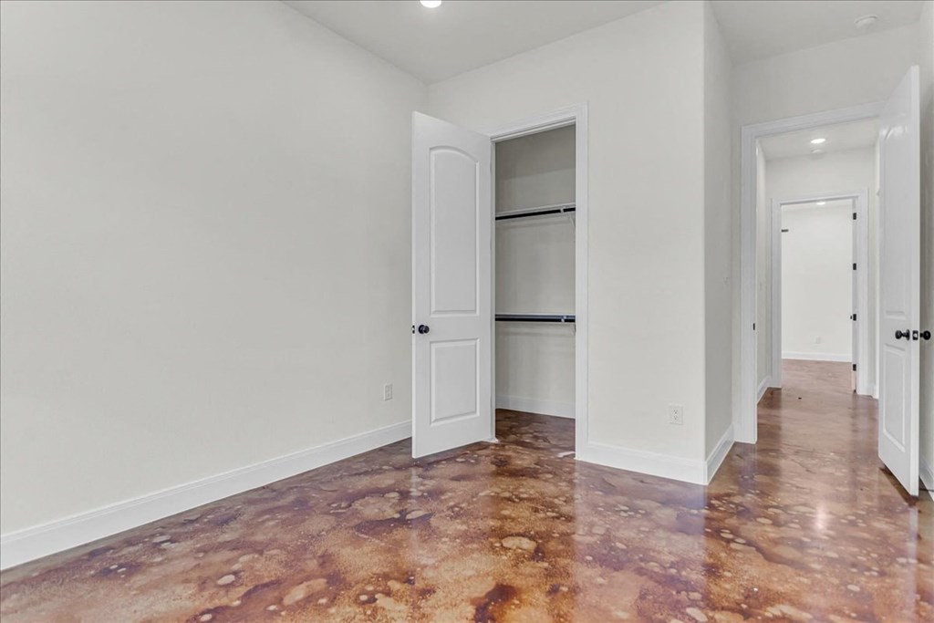 a living room with white walls and a door to a closet