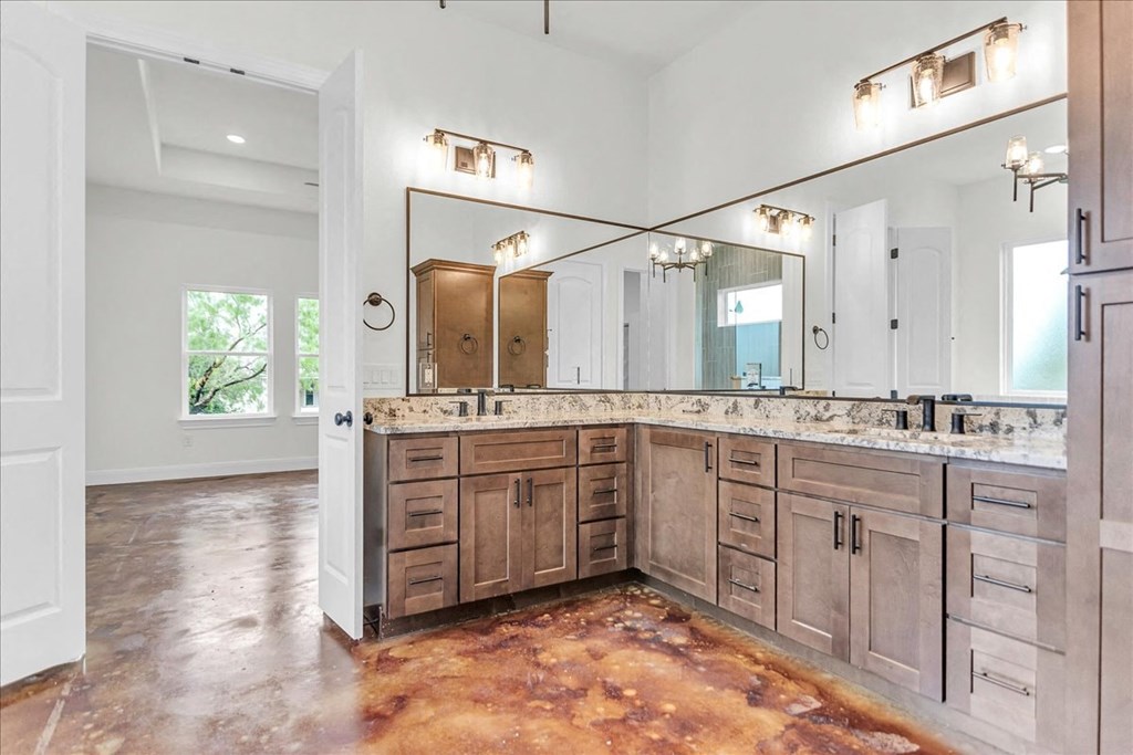 a large bathroom with wooden cabinets and a large mirror