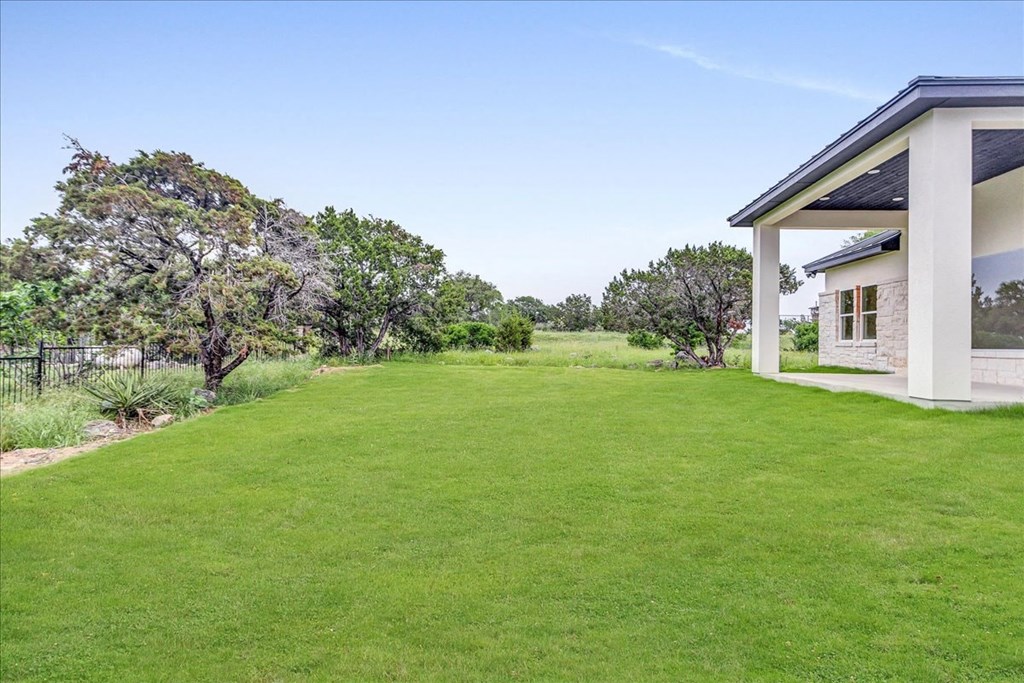 a backyard with a lawn and a house