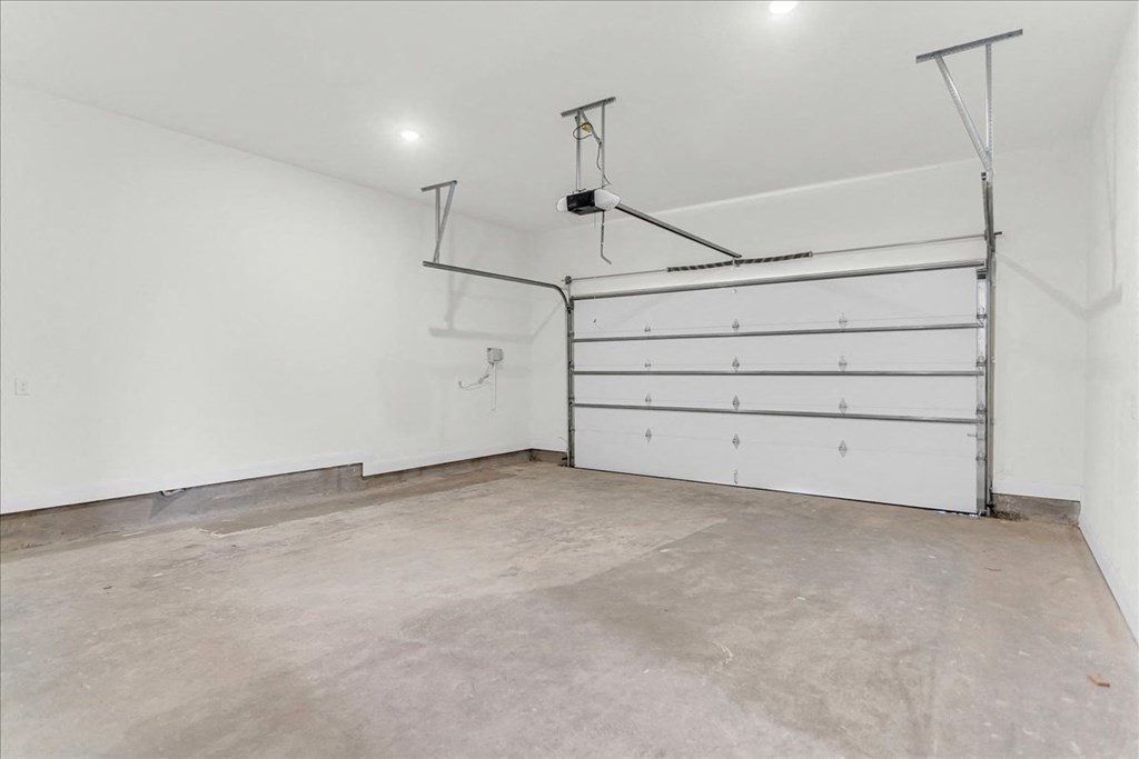 a garage with a white wall and a white garage door