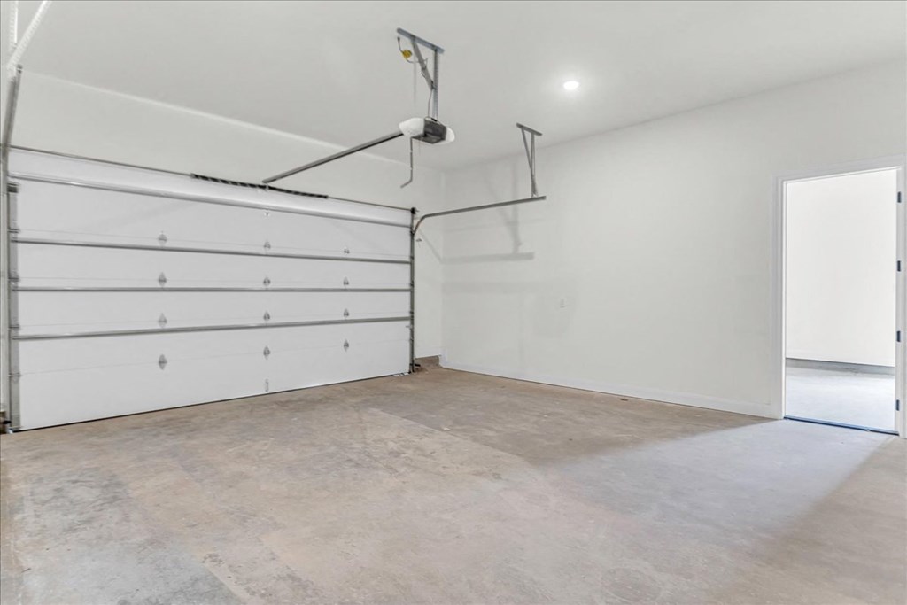 a garage with a white wall and a white garage door