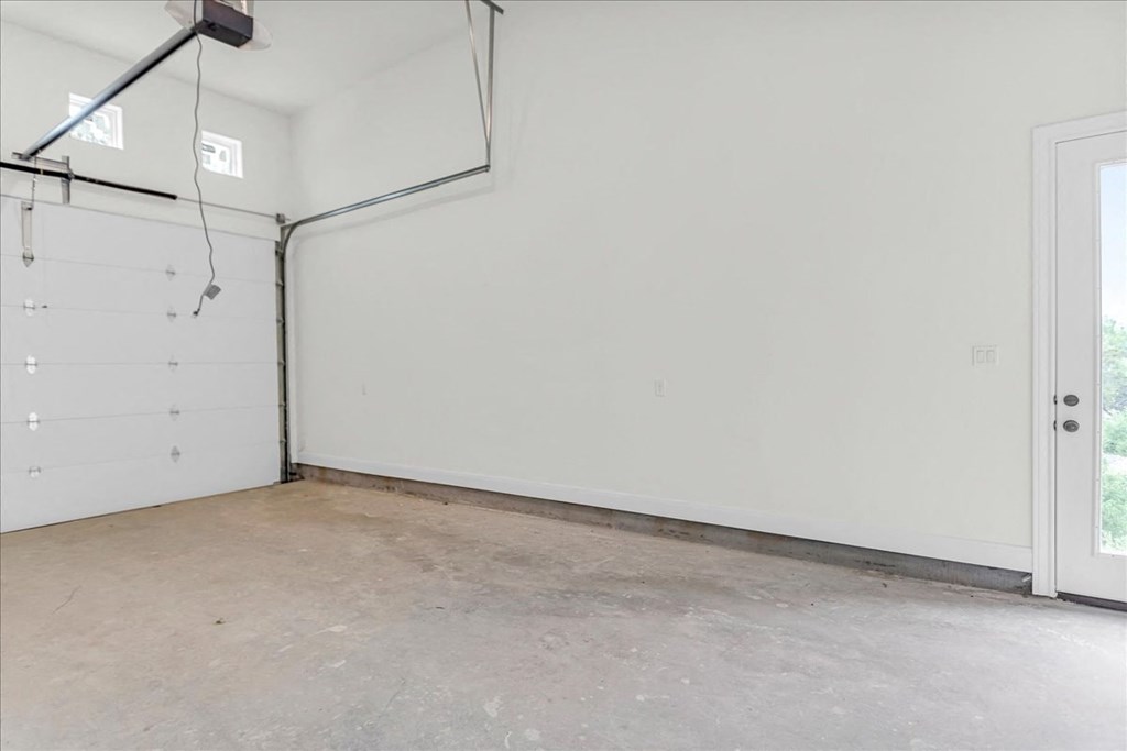 a garage with a white wall and a door
