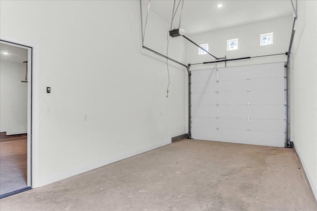 a garage with a white wall and a white door