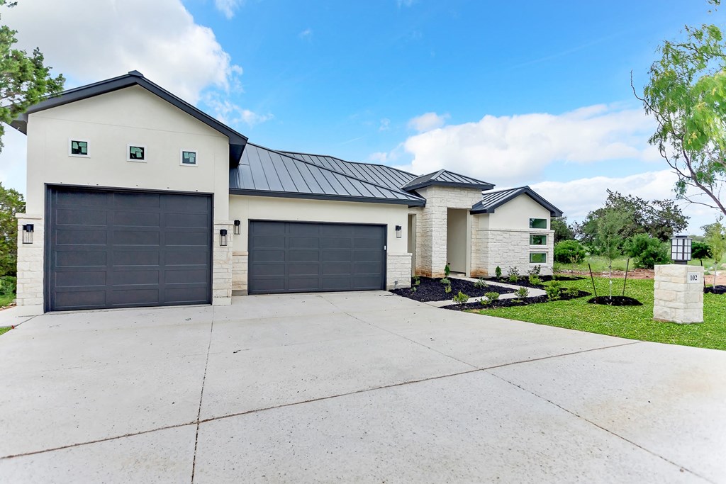 a white house with a driveway and a garage door