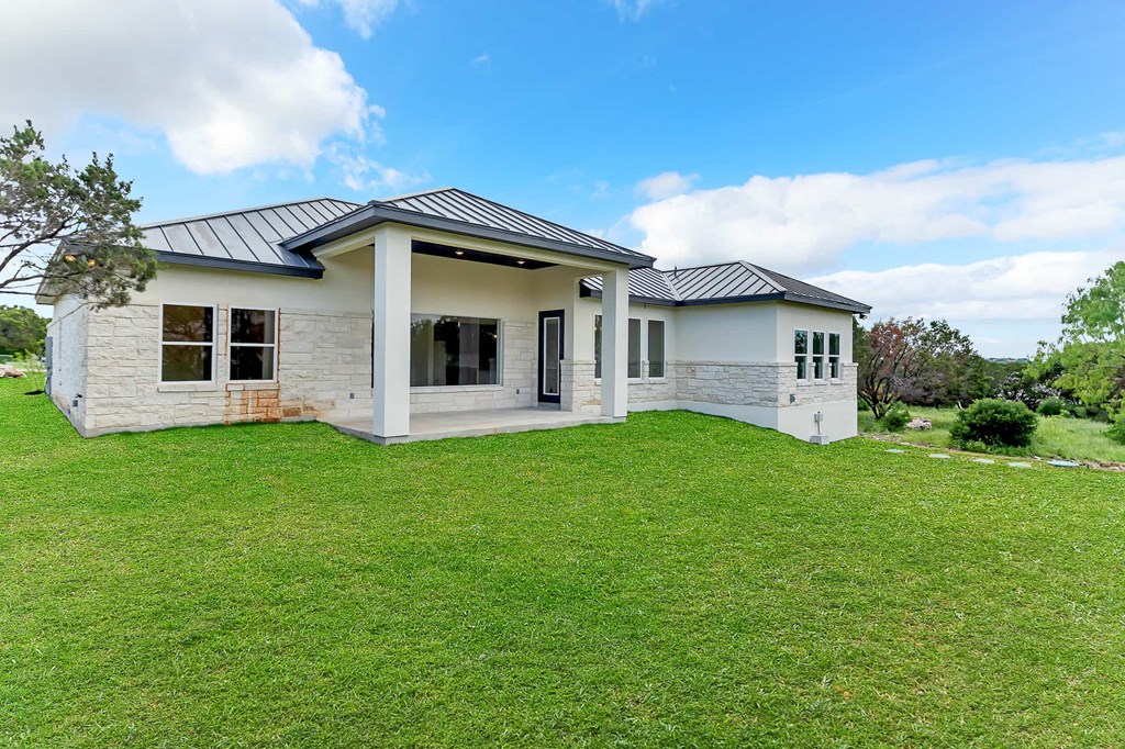 a house with a green lawn and a blue sky