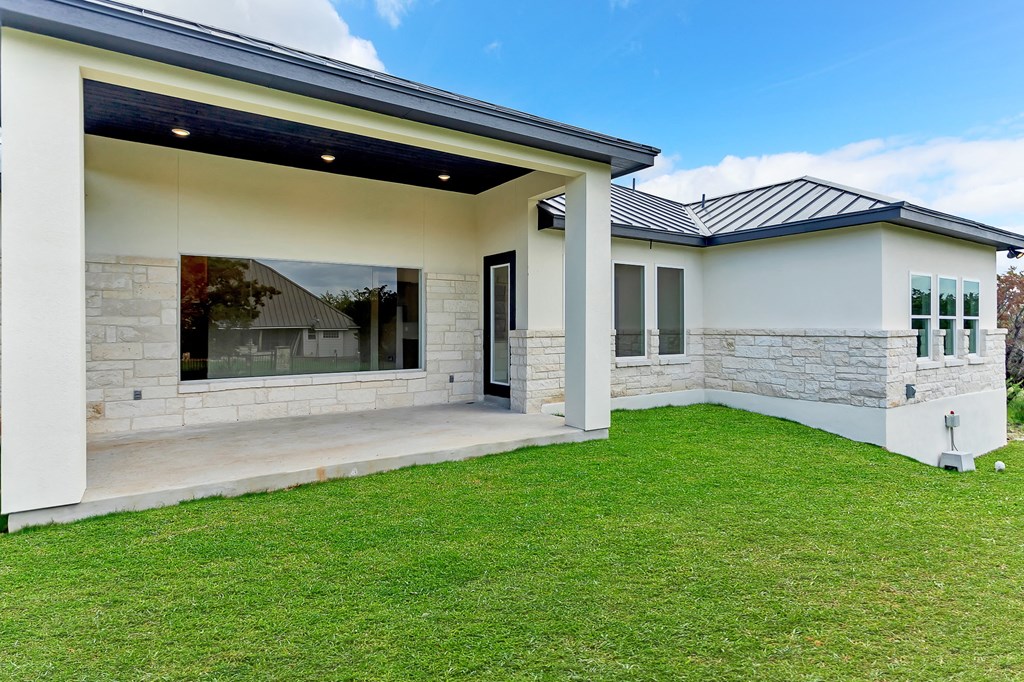 a view of the front of a house with green grass and a lawn