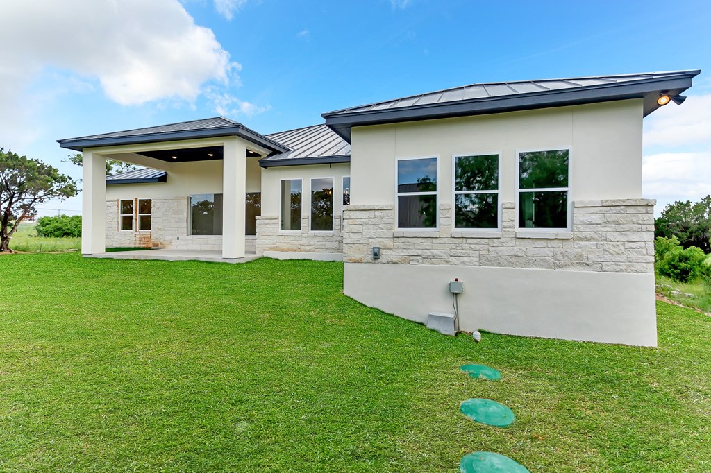 a house with a green lawn and a blue sky