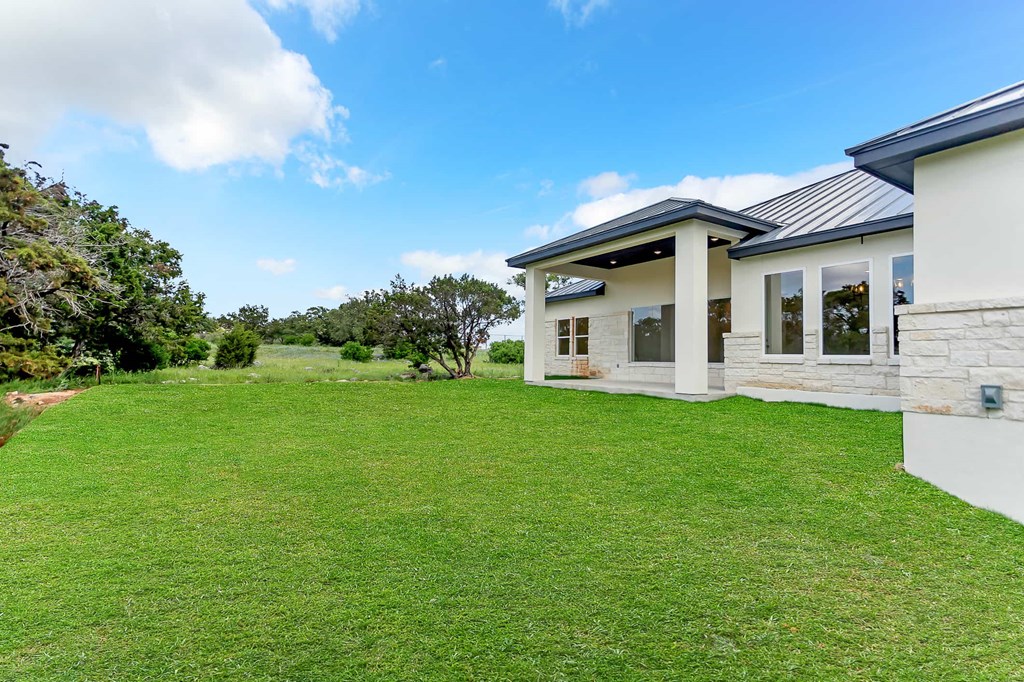 a house with a green lawn and a blue sky