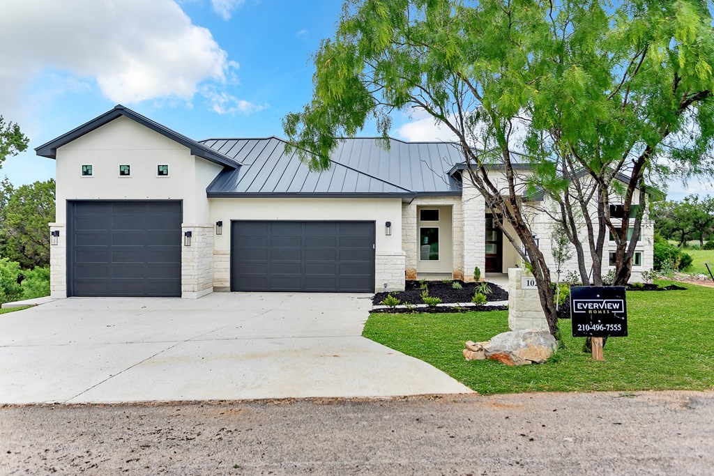 a white house with a black garage door