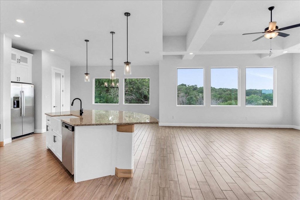 an open kitchen and living room with a large island