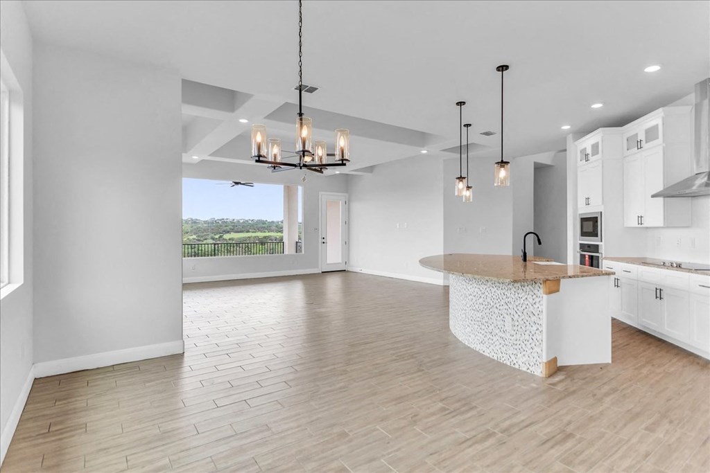 an open kitchen and living room with a large island