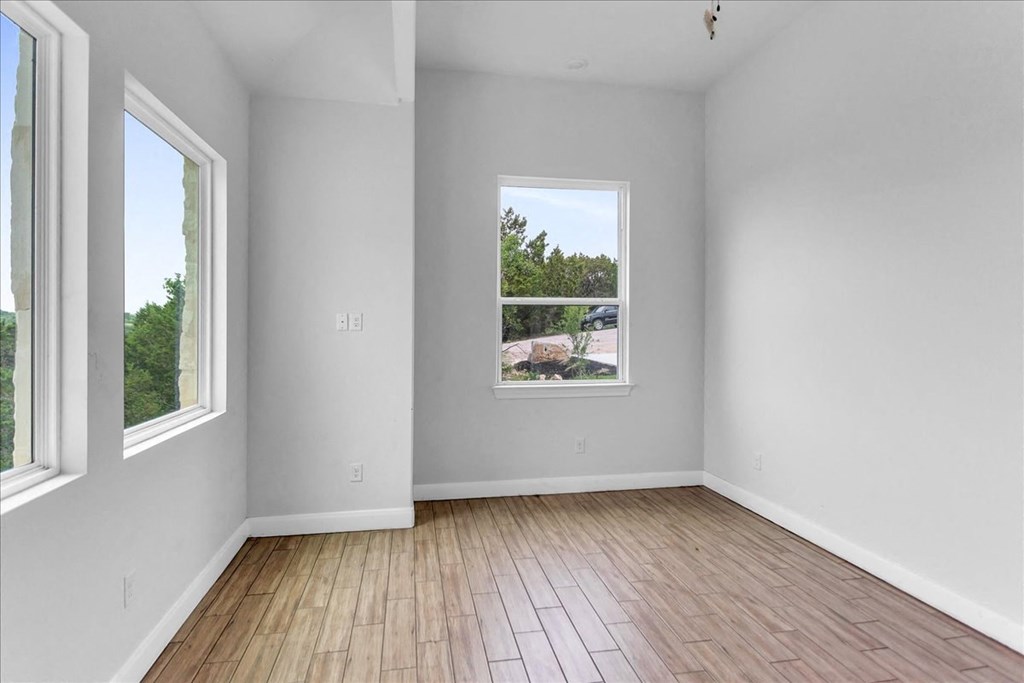 a living room with wood floors and a large window