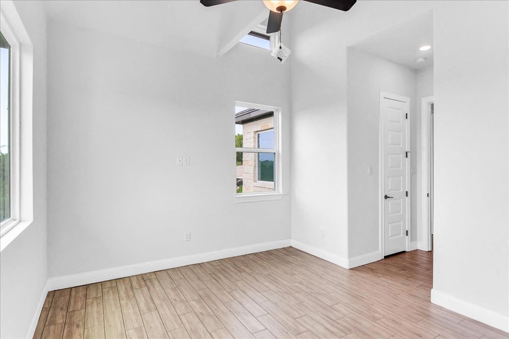 an empty living room with white walls and a window