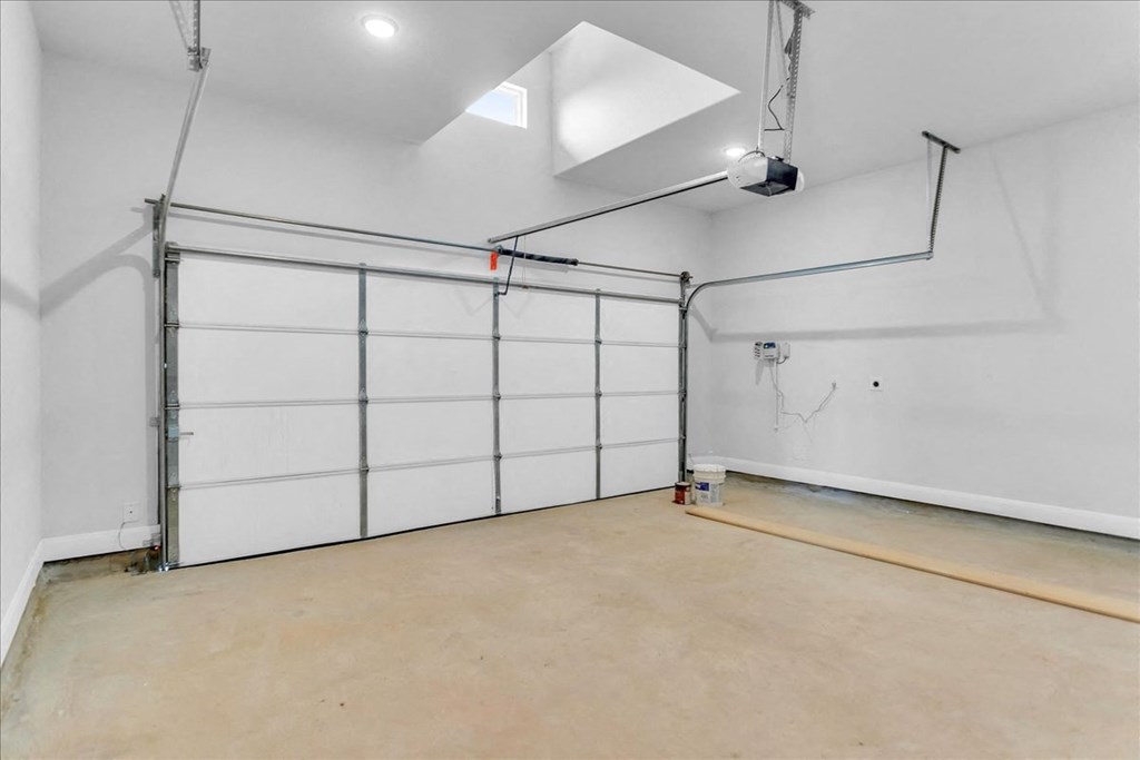 the interior of a garage with a white wall and a garage door