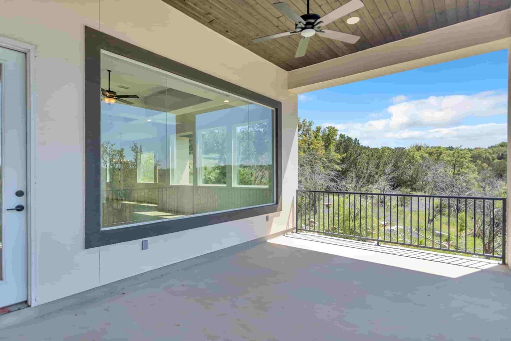 a large window on the side of a house with a balcony