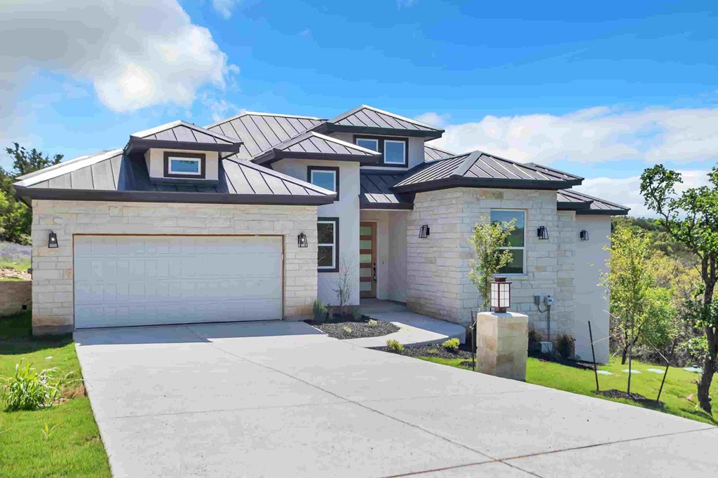 a white house with a garage and a driveway
