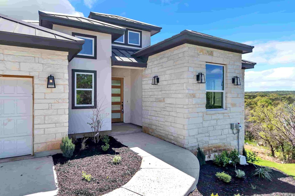 a white house with a sidewalk and a garage