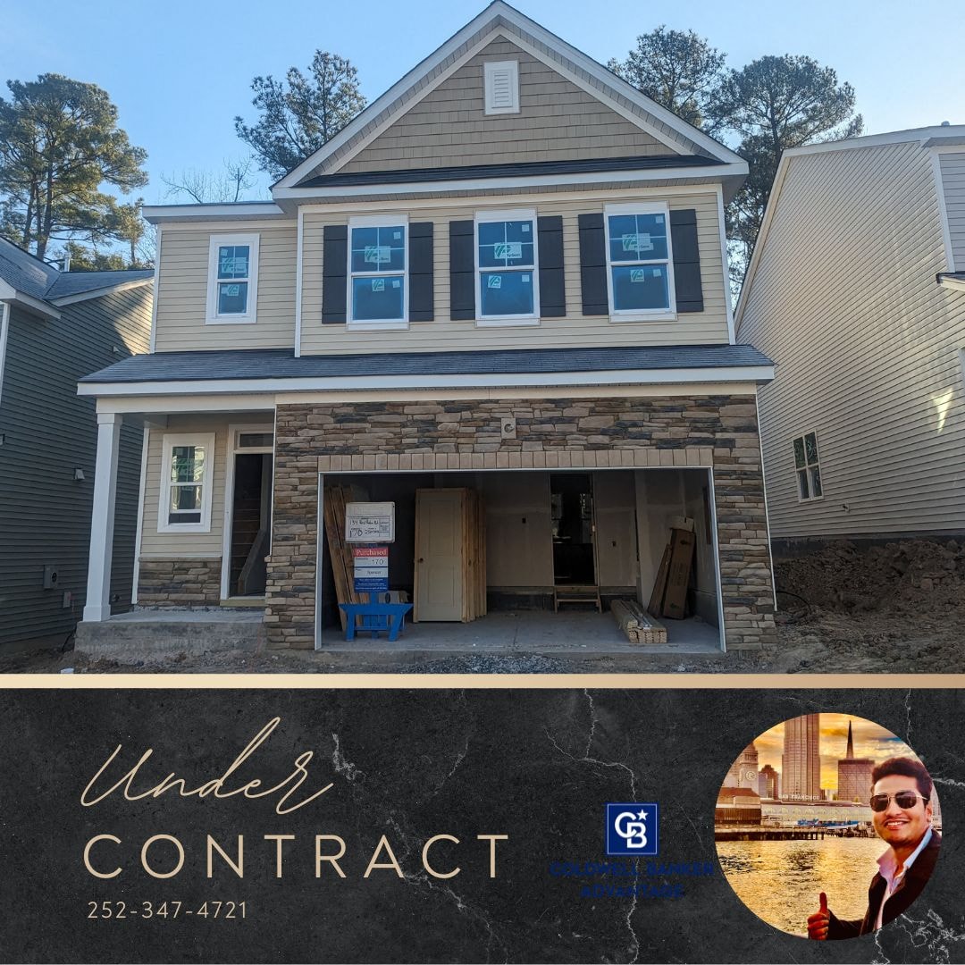 a home being remodeled with a sign in front of it