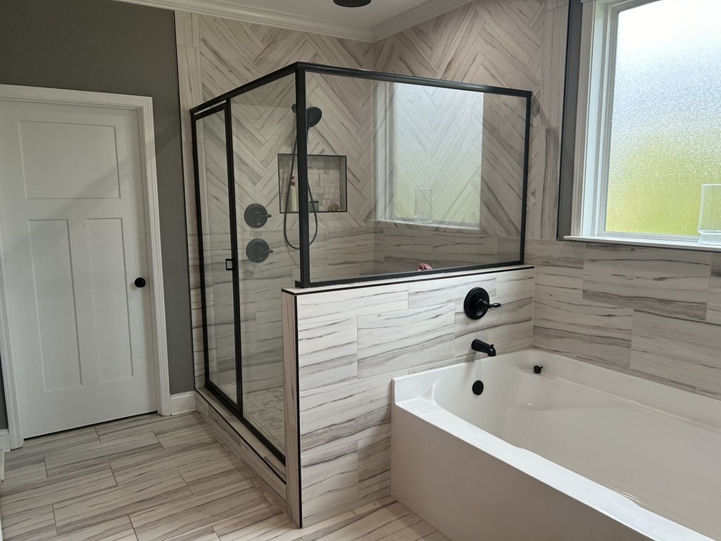 the master bathroom has a soaking tub and a walk in shower