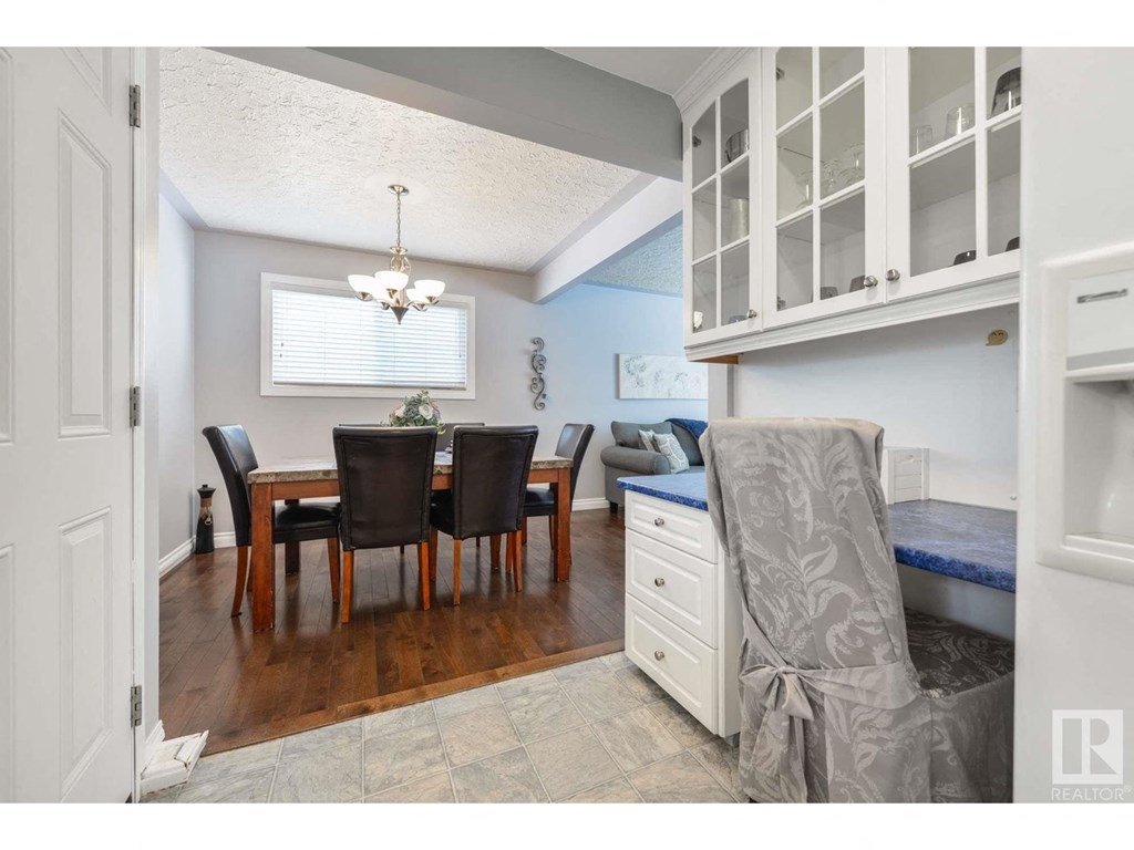 a dining room and kitchen with a table and chairs