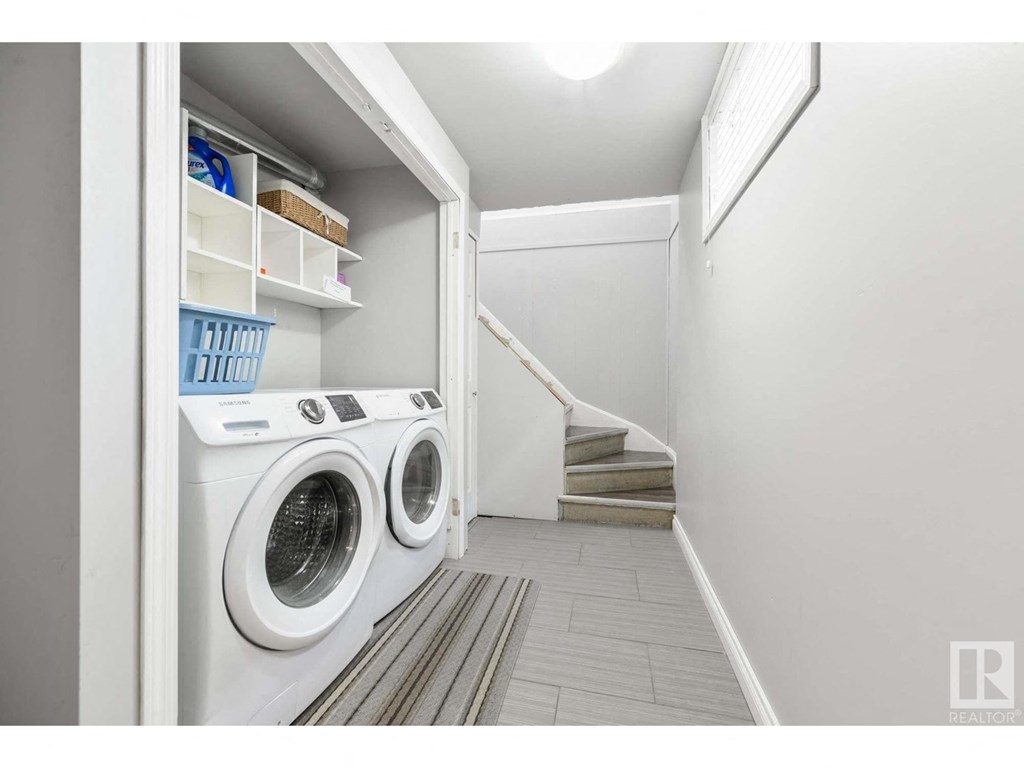 a washer and dryer in a laundry room with stairs