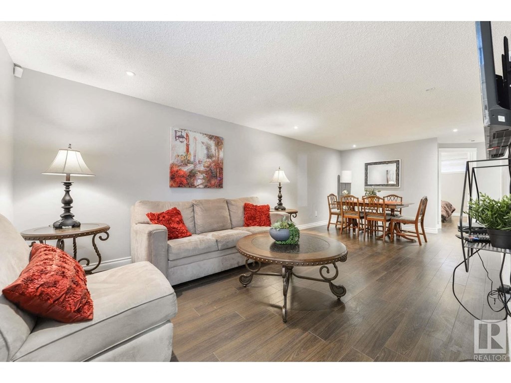 a living room and dining room with couches and a table