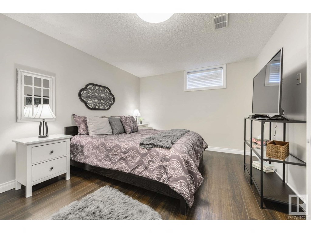 a bedroom with a bed and a mirror